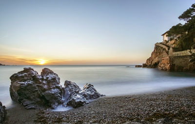 Scenic view of sea against clear sky during sunset