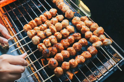 High angle view of person preparing food on barbecue grill