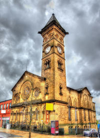 Low angle view of clock tower against sky