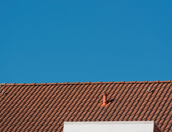 Roof of building against blue sky