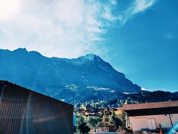 Townscape by mountains against sky