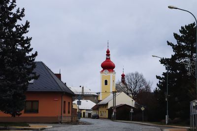 View of church and buildings against sky