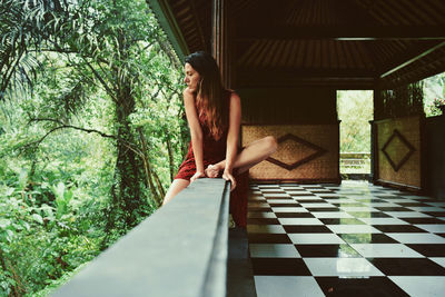 Young woman relaxing on tiled floor