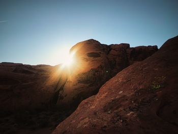 Rock formations on landscape against clear sky