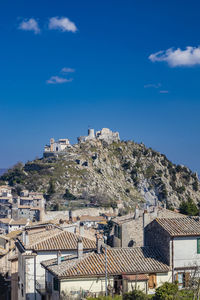 Buildings in town against sky