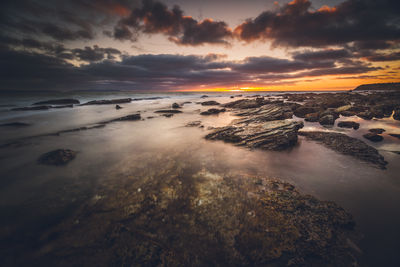 View of sea against cloudy sky during sunset