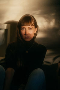 Portrait of thoughtful woman sitting at home