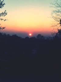 Silhouette trees against sky during sunset