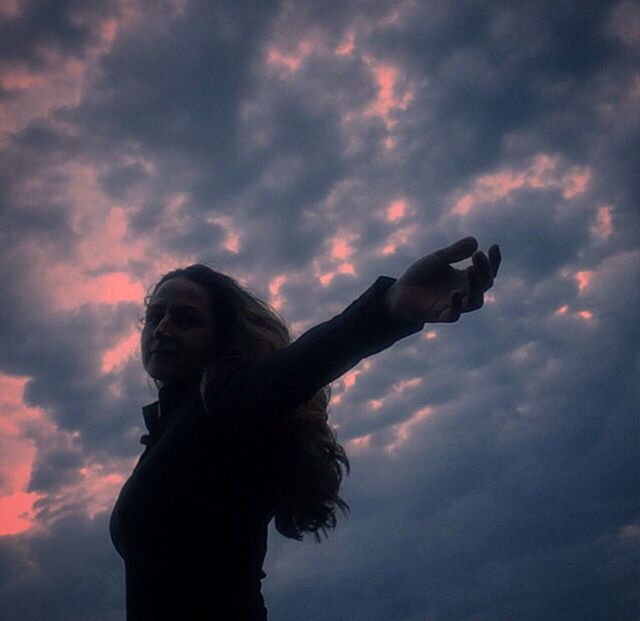 LOW ANGLE VIEW OF STATUE AGAINST SUNSET SKY