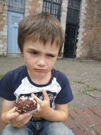 Portrait of boy holding outdoors