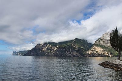 Scenic view of sea and mountains against sky