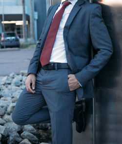 Midsection of businessman standing outdoors