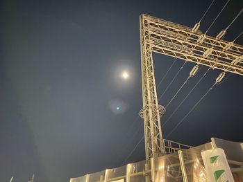 Low angle view of illuminated buildings against sky at night