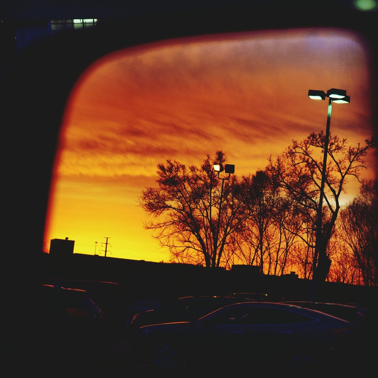 transportation, car, land vehicle, mode of transport, sunset, silhouette, sky, street light, street, road, orange color, tree, illuminated, traffic, travel, cloud - sky, dusk, on the move, bare tree, built structure