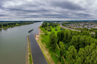Panoramic view of road by river against sky