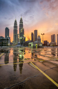 Skyscrapers against cloudy sky