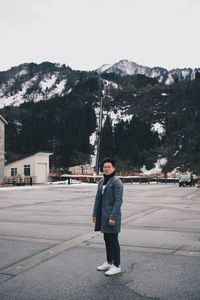 Full length portrait of man standing in snow