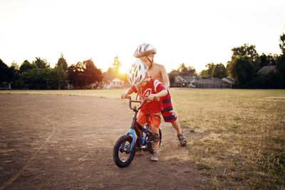 Boy on bicycle with brother