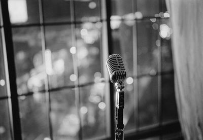 Close-up of microphone against window