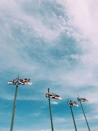 Low angle view of weather vane against sky