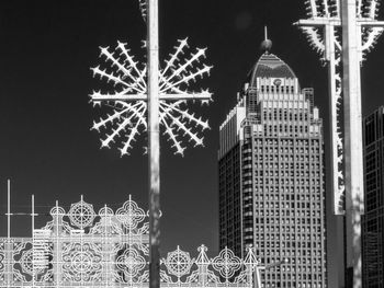 Ferris wheel in city against sky at night