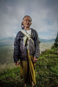 Man standing on field against sky