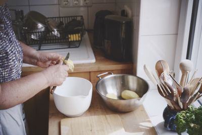 Woman peeling potatoes