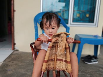 Full length of woman sitting in basket