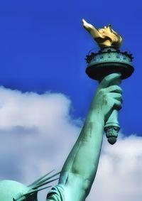 Low angle view of statue against blue sky