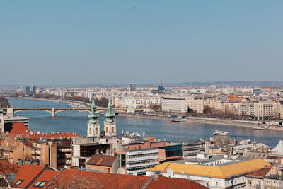 High angle view of buildings by sea against clear sky