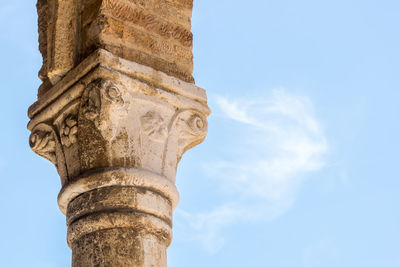 Low angle view of column against sky