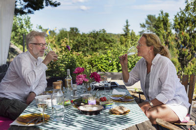 Mature couple having meal in garden