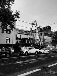 Cars on road against sky in city