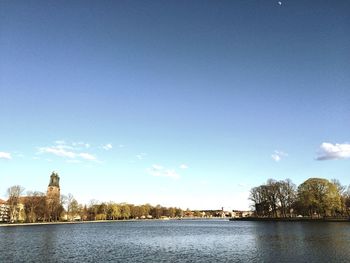 Scenic view of river against blue sky