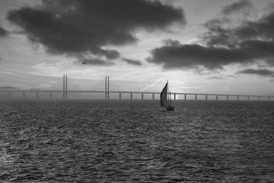 Suspension bridge over sea against sky