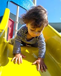 Cute boy on slide in playground
