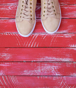 High angle view of shoes on red floorboard