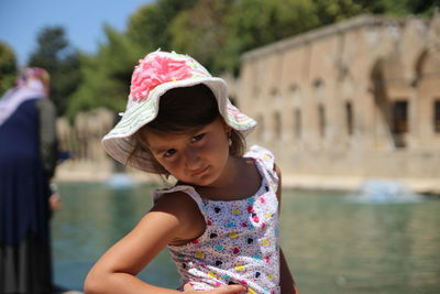Portrait of cute girl against water