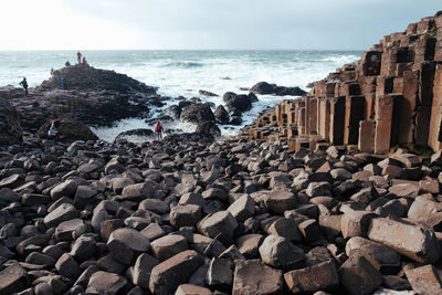 Panoramic view of rocks on beach against sky