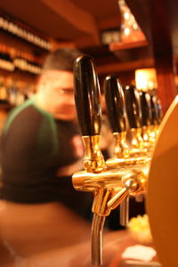 Close-up of faucets in bar