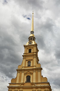 Low angle view of bell tower against cloudy sky