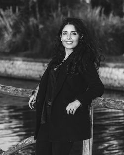 Portrait of smiling young woman standing in water