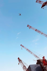 Low angle view of airplane flying against clear sky