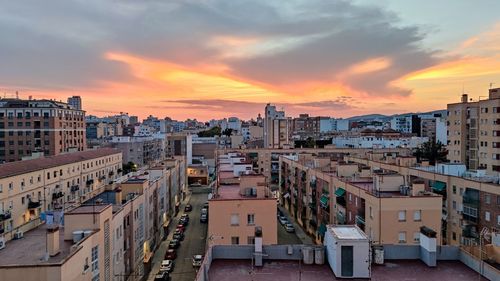 High angle view of buildings in city against sky during sunset