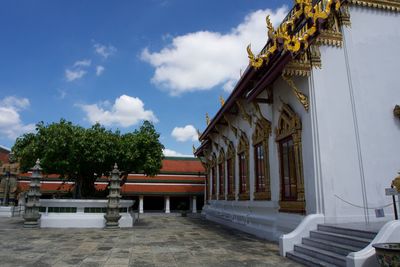 Temple by building against sky