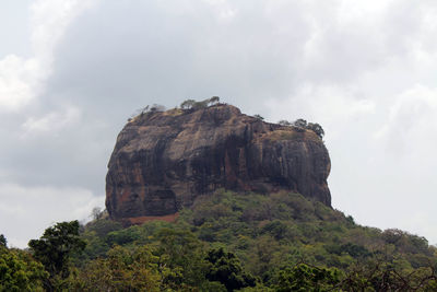 Low angle view of rock formations against sky