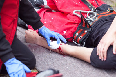 Close-up of paramedics examining man
