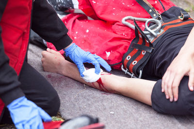 Midsection of friends lying on street