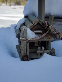 Close-up of logs on snow covered land