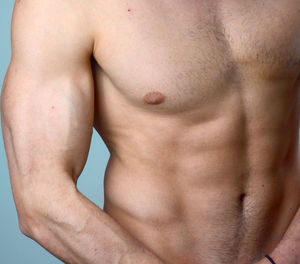 Midsection of shirtless man
